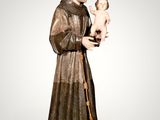 a statue of a man holding a baby in his arms