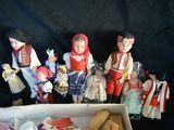 a box full of dolls and other items on a table