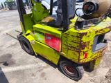 a yellow forklift with a helmet on top of it