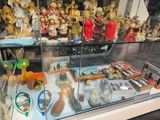 a glass display case with many different items in it