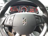 a steering wheel and dashboard of a car with various gauges