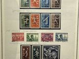 a framed picture of a group of stamps on a wall