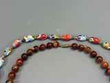 two necklaces that have different designs on them