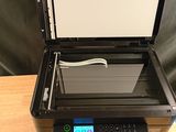 a printer that is sitting on a table next to a keyboard