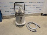 an image of a vacuum with a hose on the floor