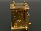 a gold clock that is sitting on a table