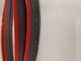 two red and black rings hanging on the wall of a store