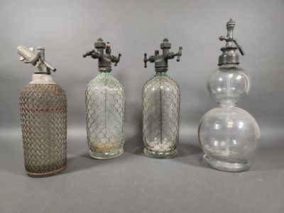 three antique glass bottles and a faucet on a gray background