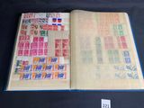 an open book with stamps on it on a table