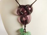 Collier composé de perles de verre violettes et vertes, porté par un mannequin blanc