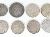 six different british coins are arranged in a row on a white surface