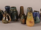 a lot of vases that are sitting on a table