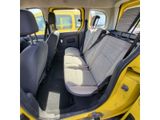 the back seats of a yellow car with a black seat belt