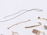 many different types of jewelry on a white surface