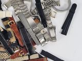 many different types of watches and other accessories on the table
