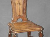 an image of a wooden chair with a carved back and seat