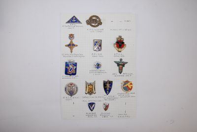 a bunch of badges on a piece of paper on the wall