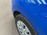 a close up of a blue car parked on the side of the road
