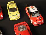 several toy cars are lined up in a row on a black surface