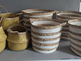 several baskets on a shelf in a room with a wall in the background