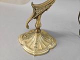 a gold plate with a bird on top of it