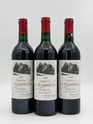 three bottles of red wine sitting next to each other on a white surface