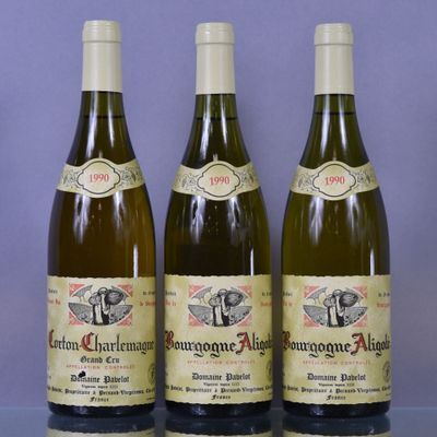 three bottles of wine sitting on a table next to each other