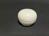 a white ball sitting on top of a black table