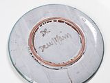 a white plate with a brown rim and a name on it