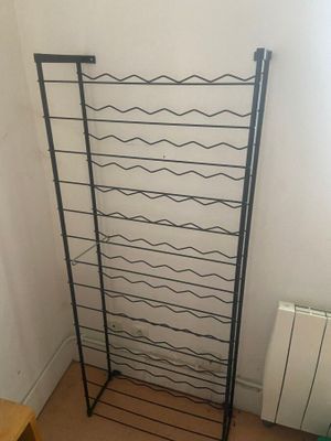 a rack that has a bunch of wine bottles on it
