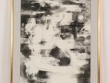 black and white abstract painting in a gold frame on a white wall