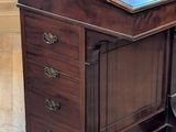 a wooden desk with a blue top on a hard wood floor