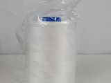 a spool of white thread sitting on top of a white table