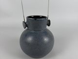 an image of a blue vase with a wooden handle on a white background