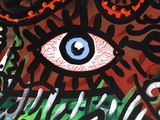 a painting of an eye with a pair of glasses on it