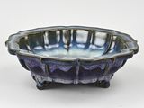 purple and blue ceramic bowl on stand on white background