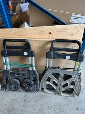 two hand trucks are sitting next to each other in a warehouse