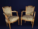 pair of louis xvi style armchairs with striped upholstered upholstered cushions