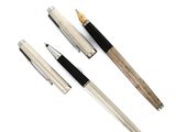 two pens and a pen sitting next to each other on a white surface