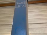 a blue pole with a sticker on it in a garage