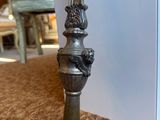 a silver vase that has a handle on it