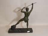 bronze statue of a man holding a spear on a marble base