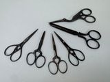 several pairs of scissors are arranged in a circle on a white surface