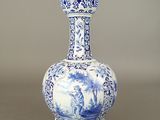 a blue and white vase sitting on a table