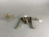 several metal animal figurines sitting on top of a table next to each other