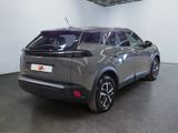 the rear end of a grey car parked in a garage