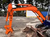 an orange excavator that is sitting in the dirt