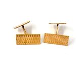 two pairs of gold cufflinks with a woven design on them