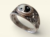silver ring with black and white stone eyes on it