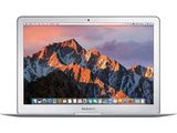 an apple macbook air laptop computer with a mountain range in the background